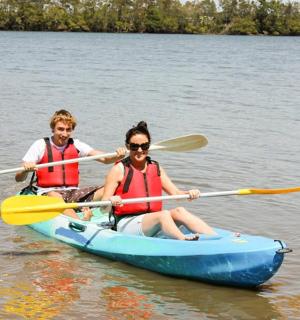 two people in a blue kayak on the water