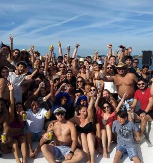 a group of people posing for a picture on a boat