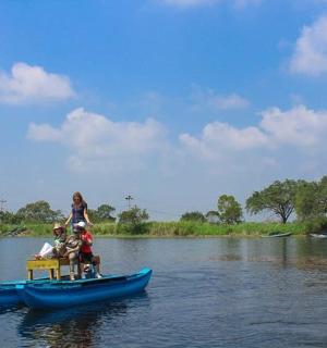 a group of people on a blue boat on a river
