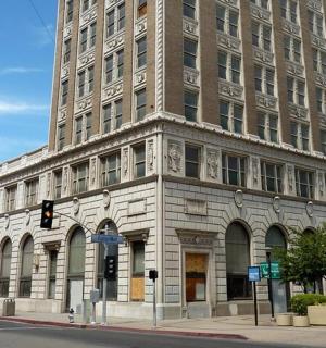 a large stone building on the corner of a street