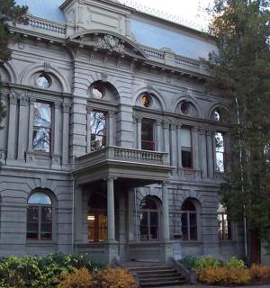 a large white building with stairs in front of it
