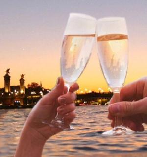 two people holding champagne glasses in front of the eiffel tower