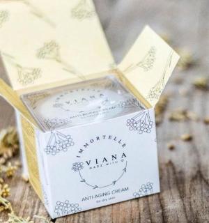 a small box with a candle on a wooden table