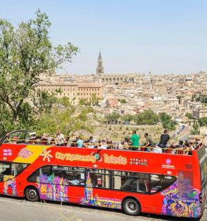 a red double decker bus with a lot of people
