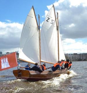 a group of people on a sail boat in the water