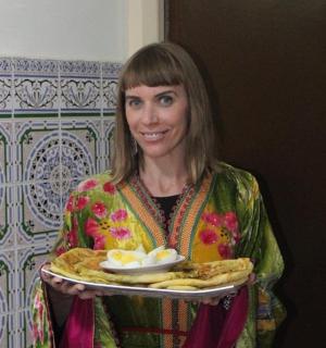 a woman is holding a plate of food