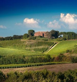a farm on a hill with a house on it