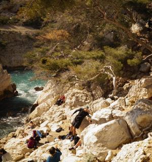 a group of people climbing up a rocky mountain