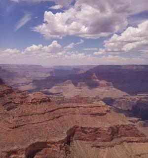 a view of the grand canyon under a cloudy sky