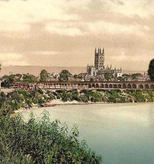 a bridge over a river with a castle in the background