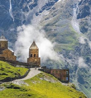 a castle on top of a hill in the mountains