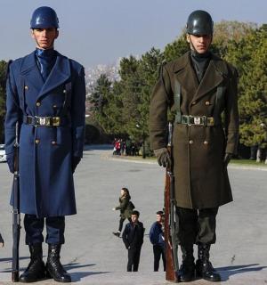 two men standing next to each other in a parking lot