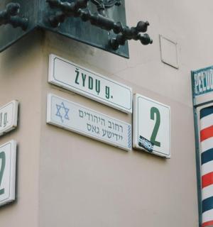 a group of street signs on the side of a building