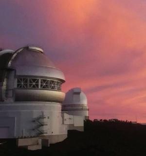 a building with two observatories and a cloudy sky