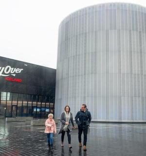 a man and woman standing in front of a building