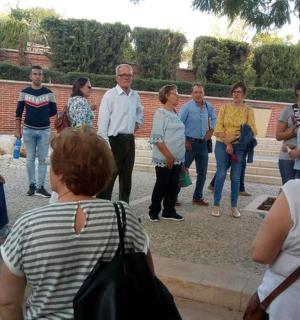 a group of people standing around in a park