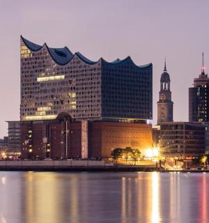 a city skyline with tall buildings in the water