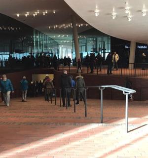 a group of people walking in front of a building