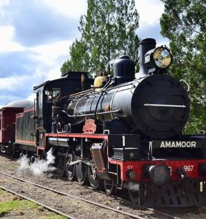 a steam engine train is on the tracks