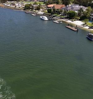 an aerial view of a boat in a body of water