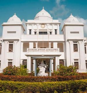 a white building with a statue in front of it