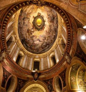 a ceiling of a building with a painting on it
