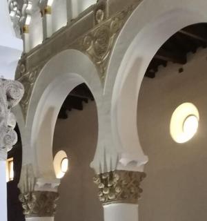 a building with arches and lights on the wall