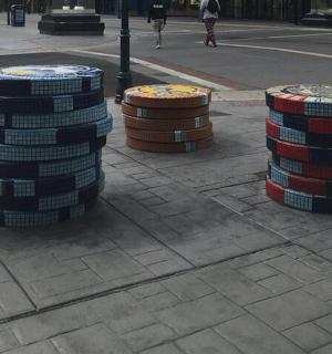three stacks of drums sitting on a city street
