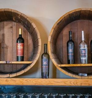 three bottles of wine sitting on a shelf