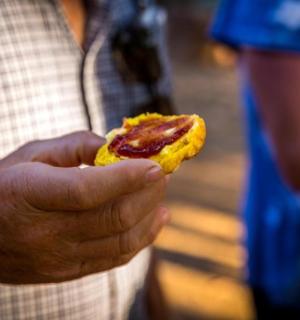 a man holding a piece of food in his hand