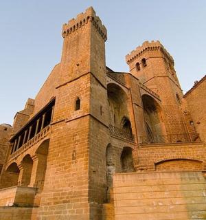 a large brick building with two towers and stairs
