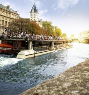 a tour boat on a river in a city