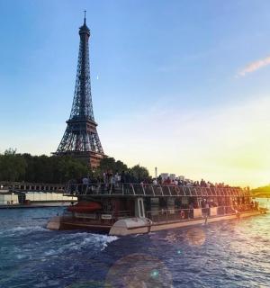 a tour boat in front of the eiffel tower