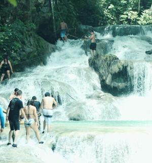 a group of people walking in a waterfall