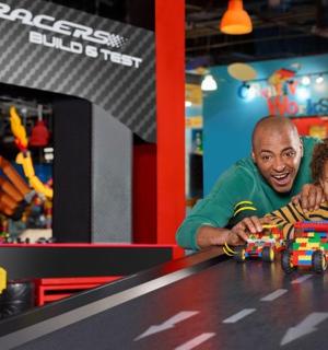 a man and a young boy playing with a toy car