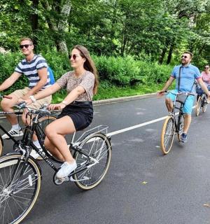 a group of people riding bikes down a road