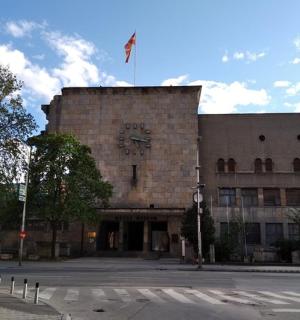 a large brick building with a flag on top of it