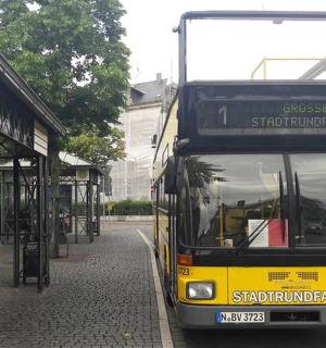 a double decker bus parked at a bus stop