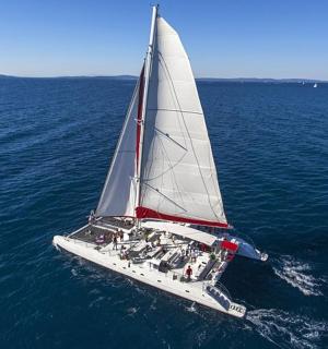a white sailboat in the middle of the ocean