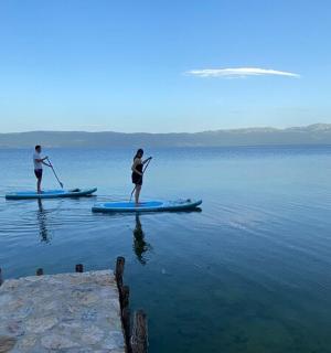 two people are standing on paddle boards in the water