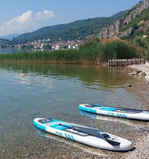 two kayaks sitting on the shore of a lake