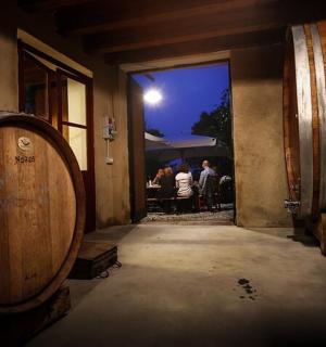 a wine barrel in a room with a group of people