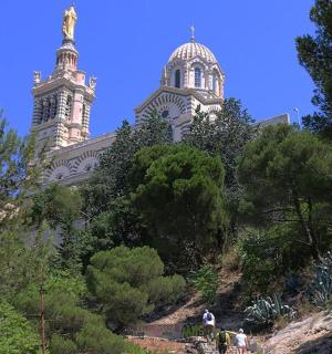 a building with two towers on top of a hill