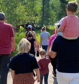 a group of people walking down a trail
