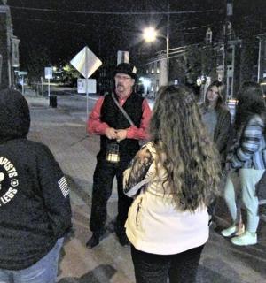 a group of people standing on a street at night