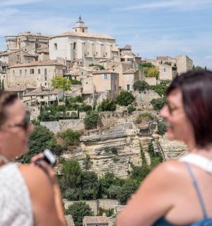 two women are looking up at a mountain