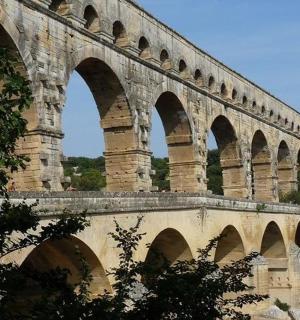 a bridge with arches on top of a mountain