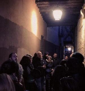a group of people standing in a dark alley