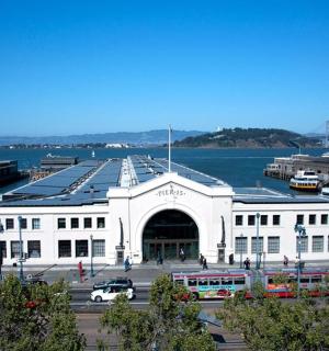 a large white building next to a body of water
