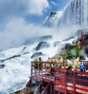 a group of people standing in front of a waterfall